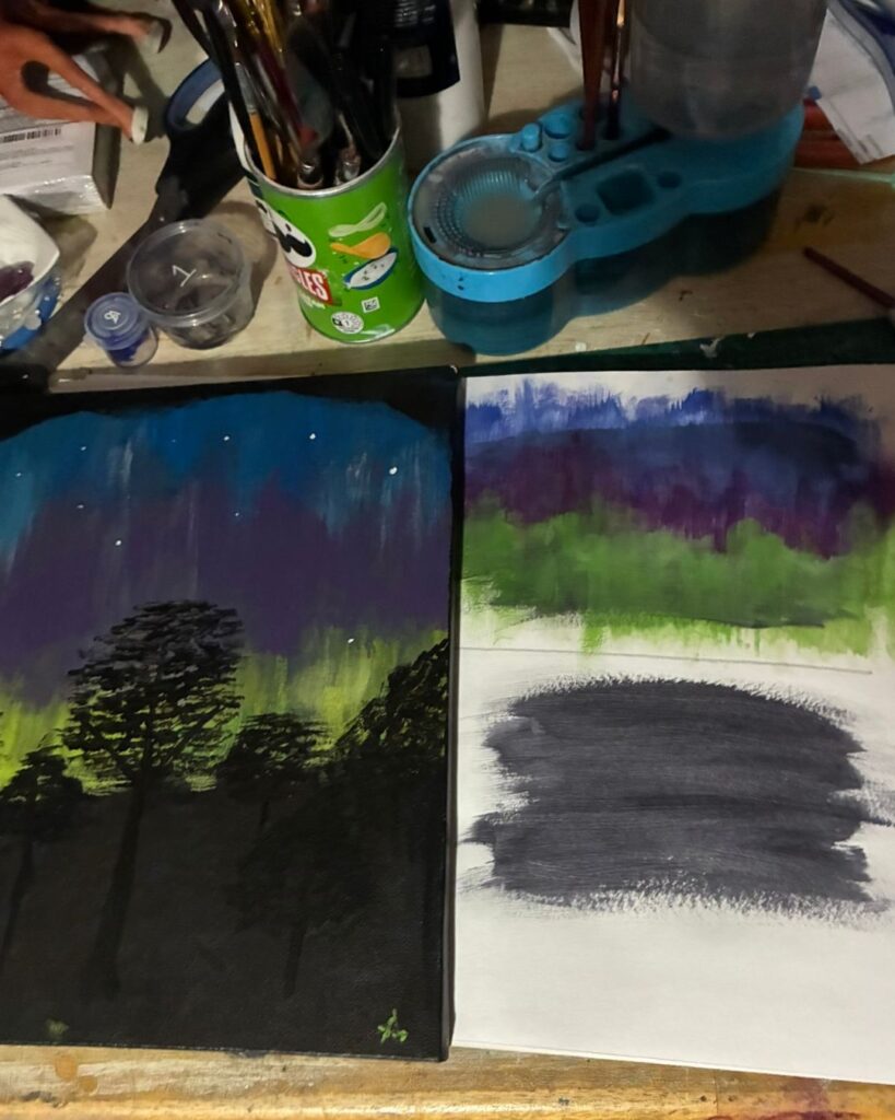 Aurora paintings and painting materials on Amanda Sutherland's work table