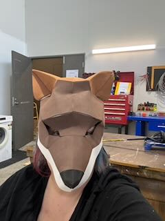 Amanda Sutherland wearing a handmade animal mask during a mask-making project