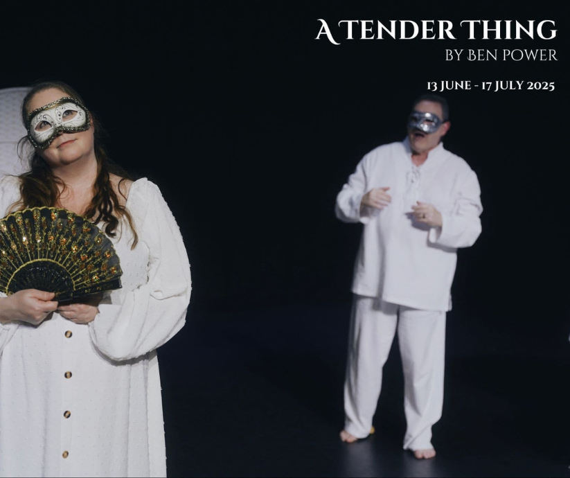 Two masked performers in white costumes illuminated against a dark stage in A Tender Thing, a 2025 Tasmanian Theatre Company production.